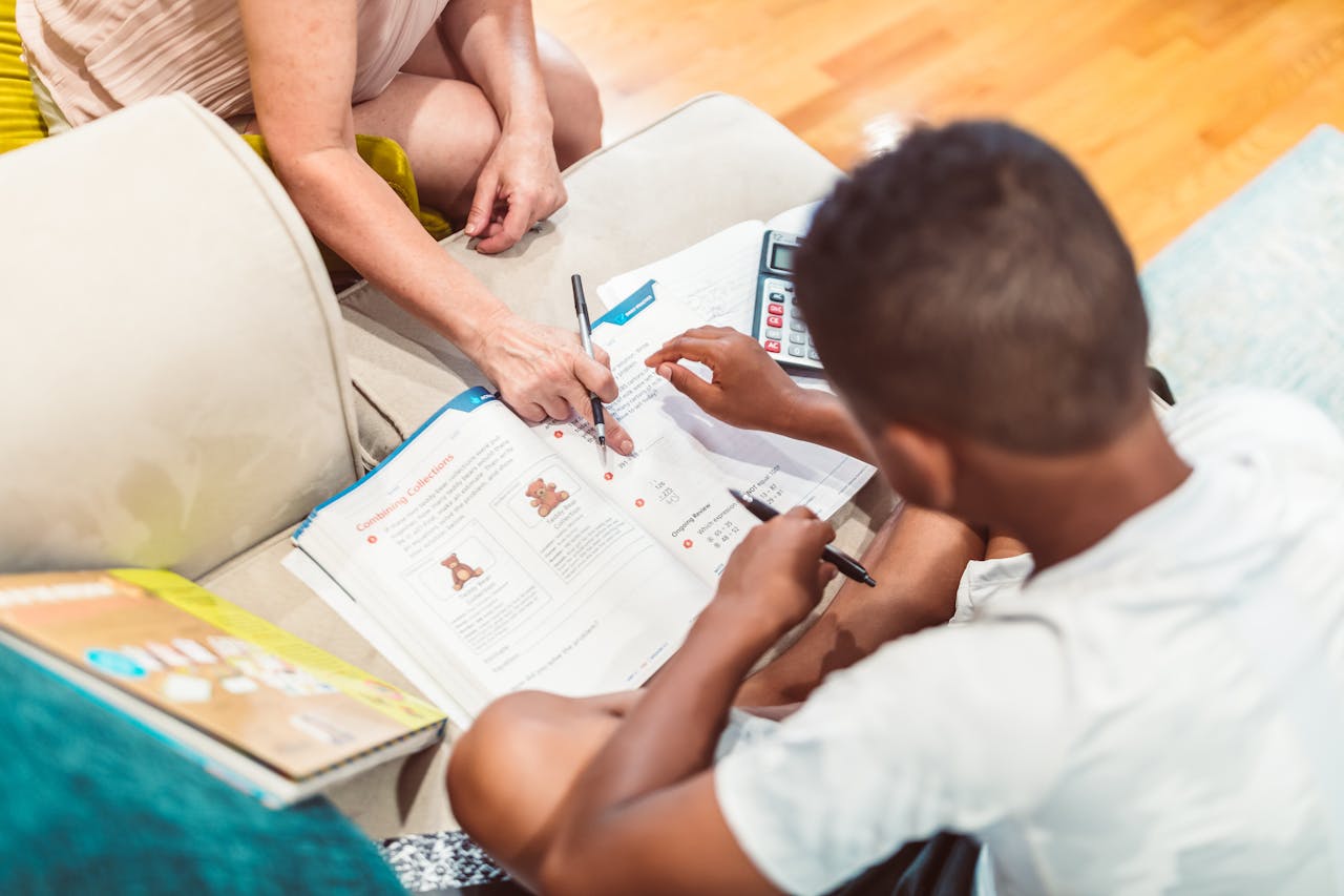 hero-img-02 A child receives tutoring assistance with homework, highlighting education and learning.